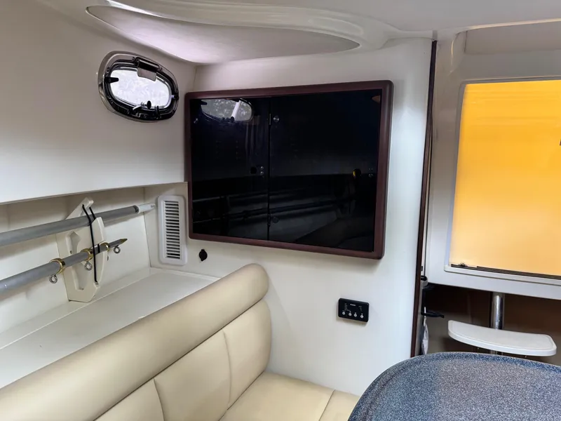 Slide: The Image of Interior of a 2011 Boston Whaler 305 Conquest boat, featuring seating and storage. - 17