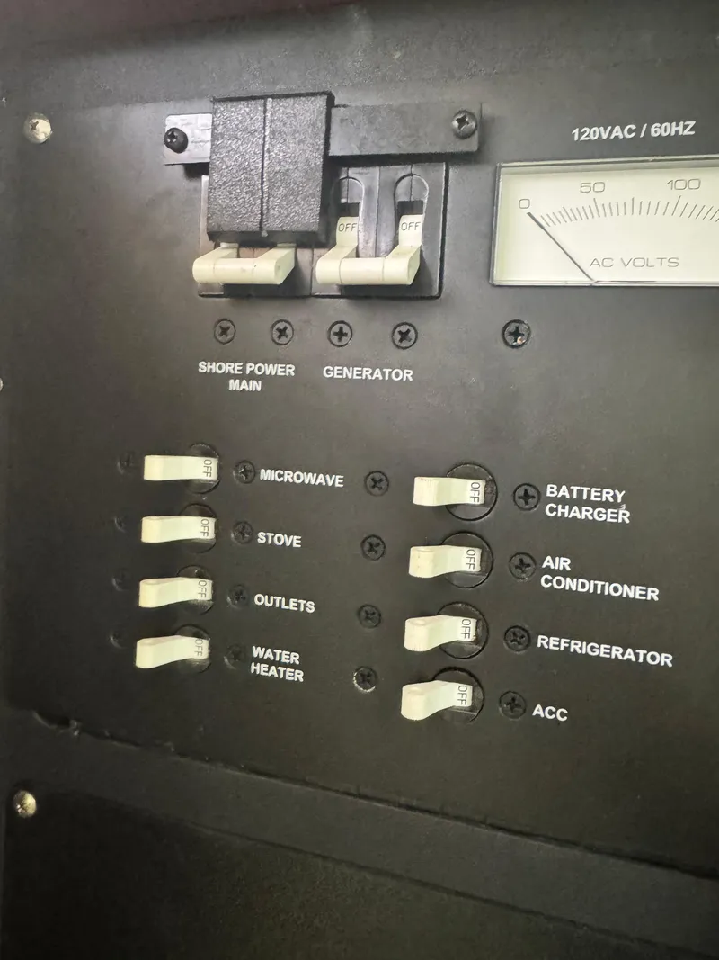 Slide: The Image of Electrical panel of a 2011 Boston Whaler 305 Conquest boat with labeled switches. - 18