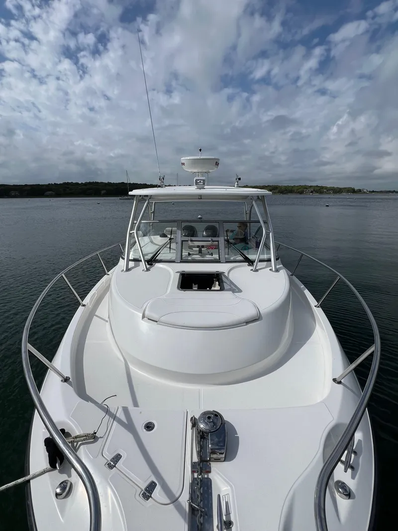 Slide: The Image of 2011 Boston Whaler 305 Conquest boat on calm water under cloudy sky. - 8