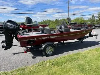 Slide: The Image of 2020 Bass Tracker Classic XL boat with Mercury engine on a trailer, parked outdoors. - 2