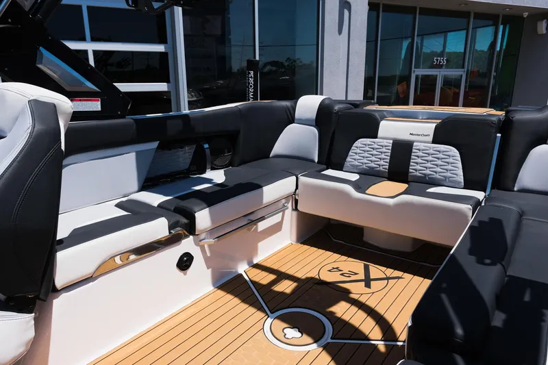 Slide: The Image of 2023 MasterCraft X24 boat interior with luxurious seating and teak flooring. - 14