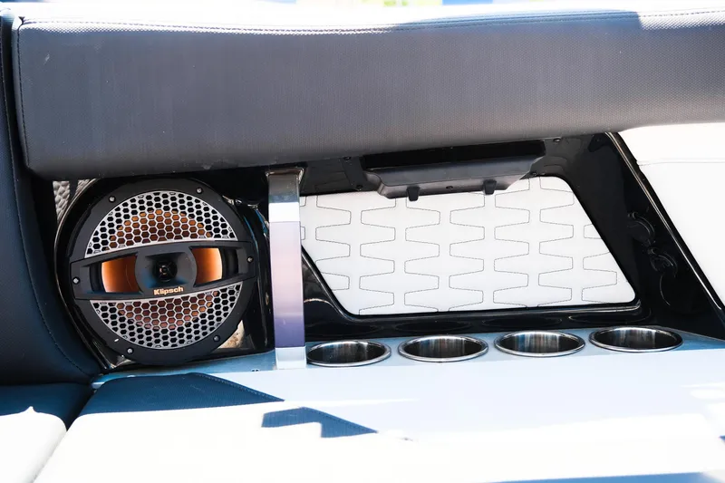 Slide: The Image of 2023 MasterCraft X24 boat interior with speaker and cup holders. - 18