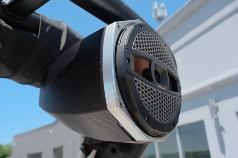 Slide: The Image of 2023 MasterCraft X24 boat speaker, close-up view under clear blue sky. - 22