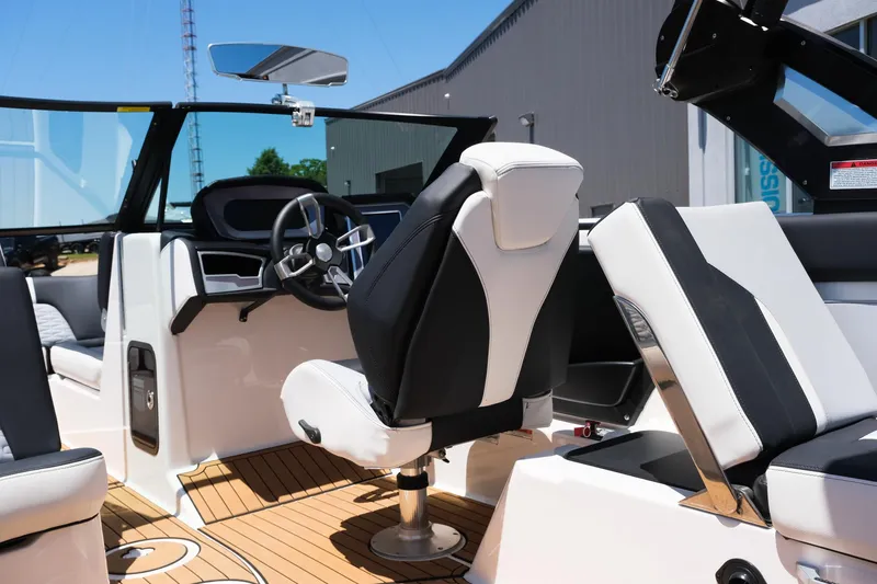 Slide: The Image of 2023 MasterCraft X24 boat interior with modern seating and steering wheel. - 24
