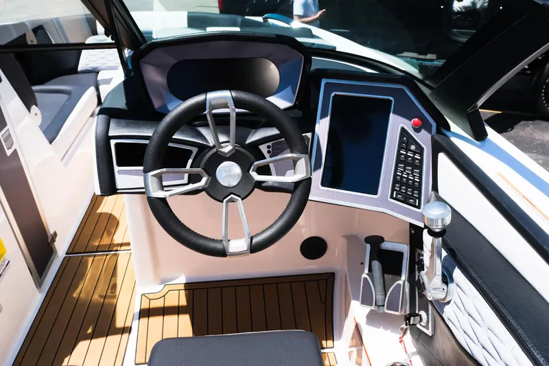 Slide: The Image of 2023 MasterCraft X24 boat cockpit with modern steering wheel and control panel. - 25