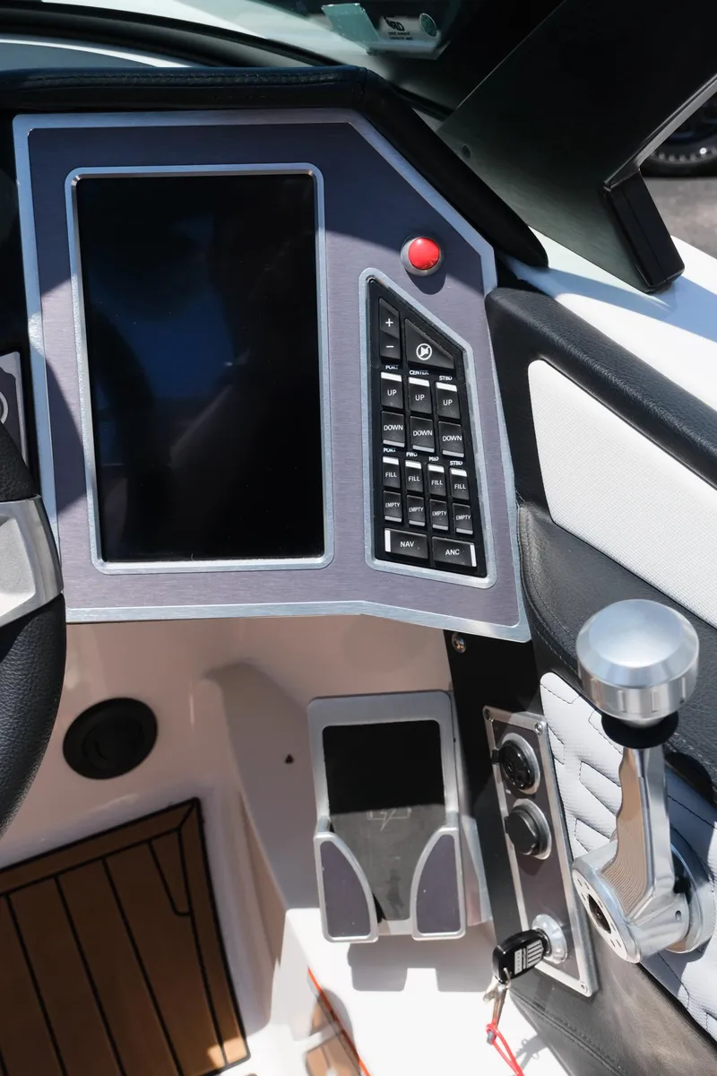 Slide: The Image of 2023 MasterCraft X24 boat dashboard with touchscreen and control panel. - 27