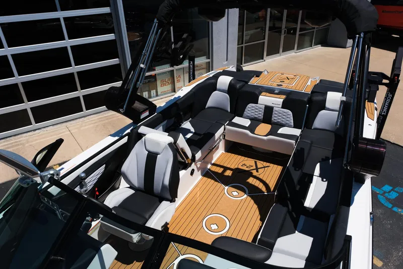 Slide: The Image of 2023 MasterCraft X24 boat interior with luxurious seating and sleek design. - 30