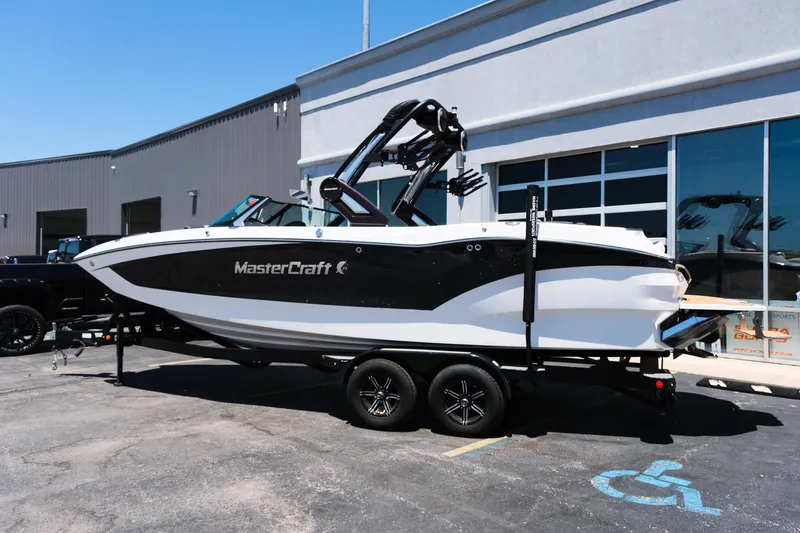 Slide: The Image of 2023 MasterCraft X24 boat on trailer outside a building. - 36