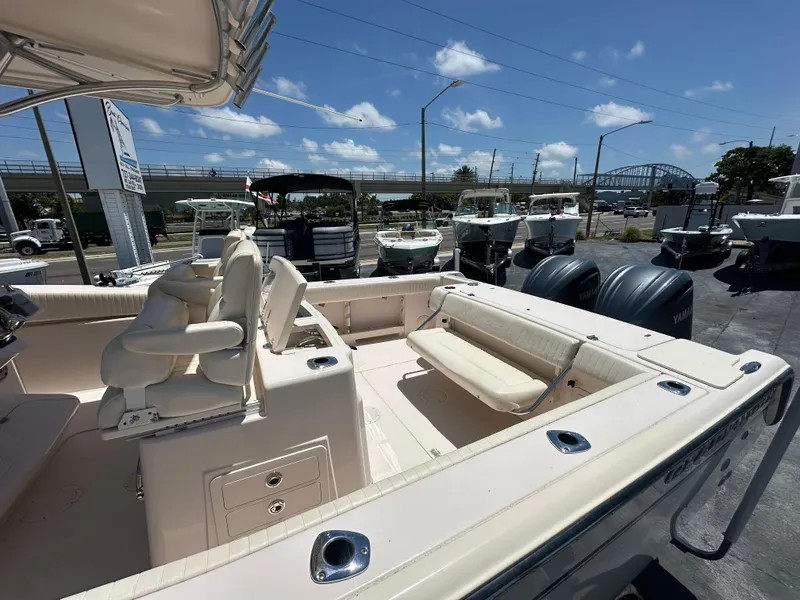 Slide: The Image of 2013 Grady-White Canyon 306 boat with dual engines, spacious seating, and clear skies. - 10