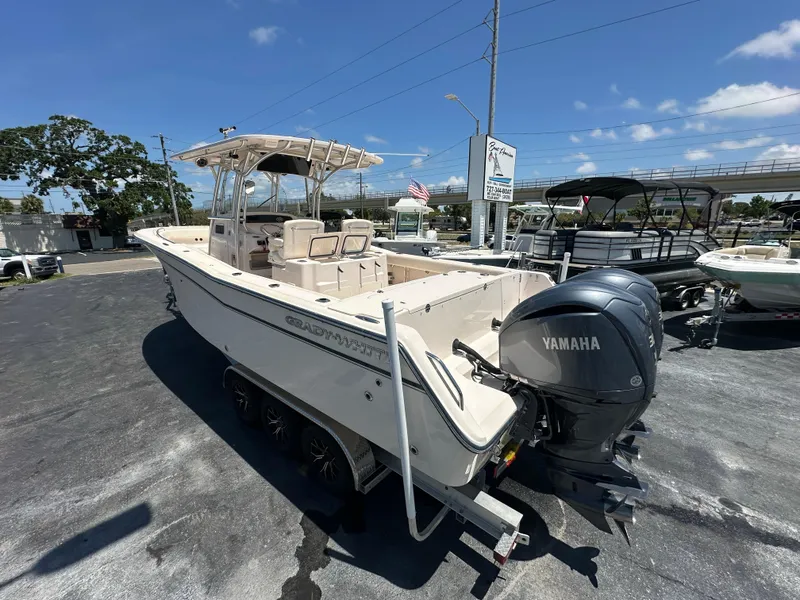 Slide: The Image of 2013 Grady-White Canyon 306 boat with Yamaha engine, parked outdoors on a sunny day. - 11