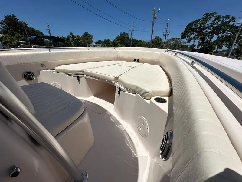 Slide: The Image of 2013 Grady-White Canyon 306 boat interior with cushioned seating and cup holders. - 21