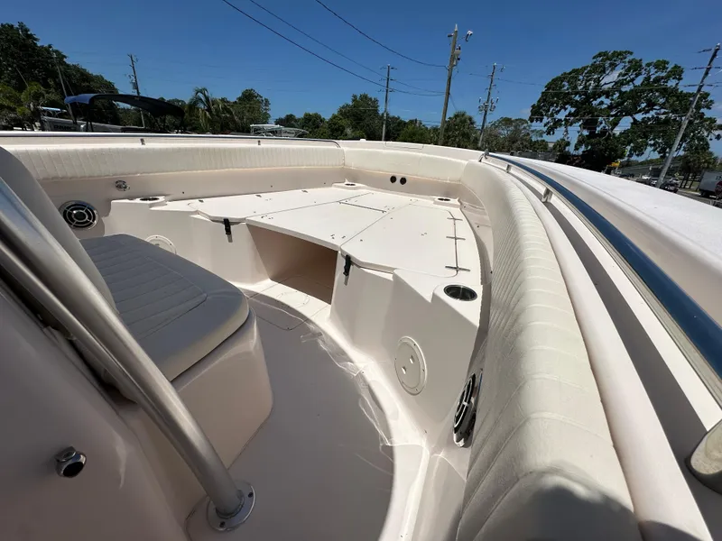 Slide: The Image of 2013 Grady-White Canyon 306 boat interior with seating and storage under clear blue sky. - 22
