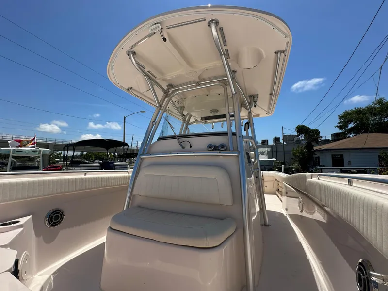 Slide: The Image of 2013 Grady-White Canyon 306 boat with T-top, viewed from the deck under a clear sky. - 24