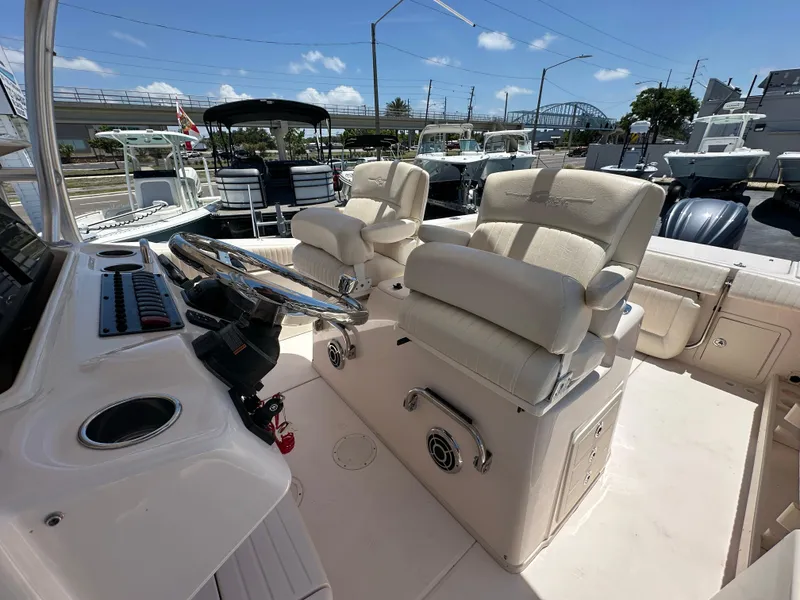 Slide: The Image of 2013 Grady-White Canyon 306 boat interior with helm and plush seating. - 29