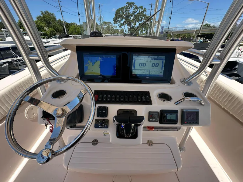 Slide: The Image of Control console of 2013 Grady-White Canyon 306 boat with navigation screens and steering wheel. - 31