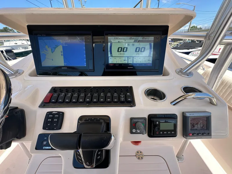 Slide: The Image of Control panel of a 2013 Grady-White Canyon 306 boat with navigation screens and controls. - 32