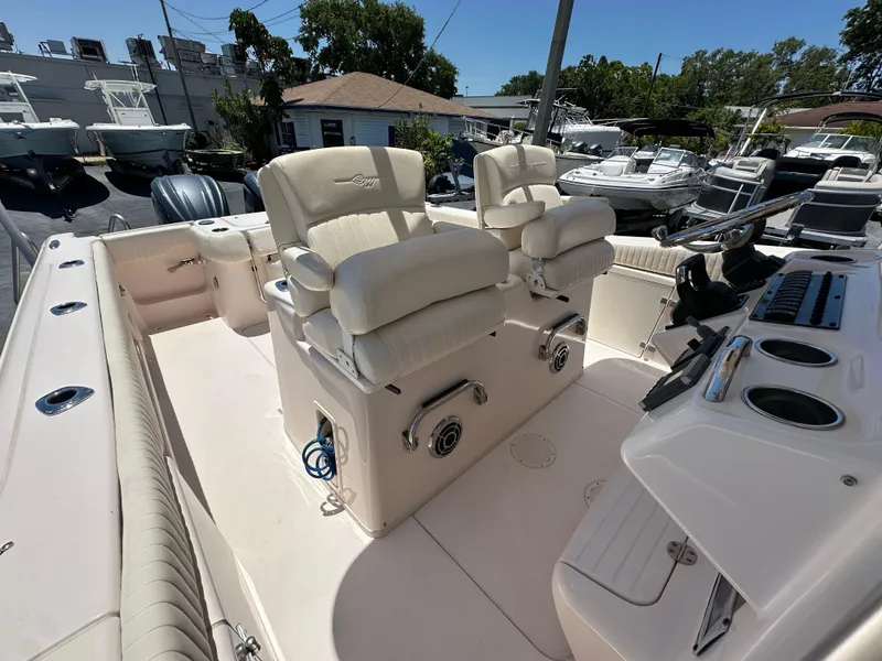 Slide: The Image of 2013 Grady-White Canyon 306 boat interior with dual captain's chairs and control panel. - 34