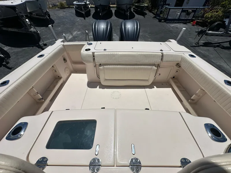 Slide: The Image of 2013 Grady-White Canyon 306 boat interior with spacious seating and storage compartments. - 37