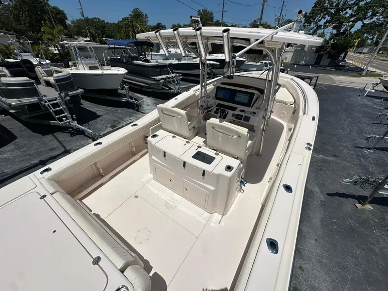 Slide: The Image of 2013 Grady-White Canyon 306 boat with spacious deck and modern controls. - 38