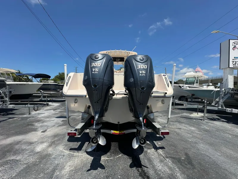 Slide: The Image of 2013 Grady-White Canyon 306 boat with twin 300 V6 engines, parked outdoors. - 4
