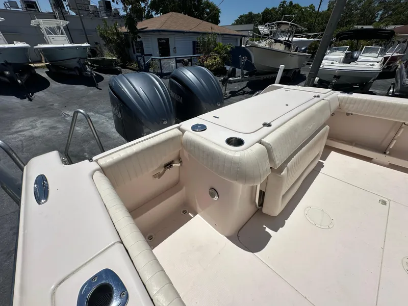 Slide: The Image of 2013 Grady-White Canyon 306 boat interior with dual outboard motors in a marina setting. - 41