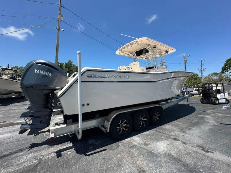 Slide: The Image of 2013 Grady-White Canyon 306 boat on trailer with Yamaha engine, parked outdoors. - 6