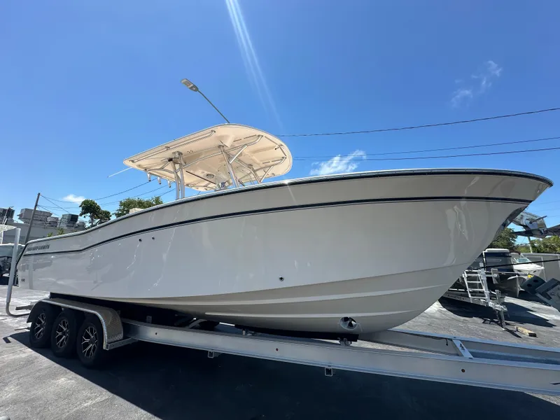 Slide: The Image of 2013 Grady-White Canyon 306 boat on trailer under clear blue sky. - 8