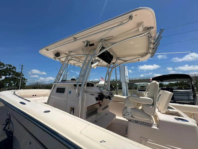 Slide: The Image of 2013 Grady-White Canyon 306 boat with T-top under clear blue sky. - 9