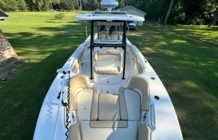 Slide: The Image of 2020 Key West 263 FS boat with beige seating on grassy area. - 10