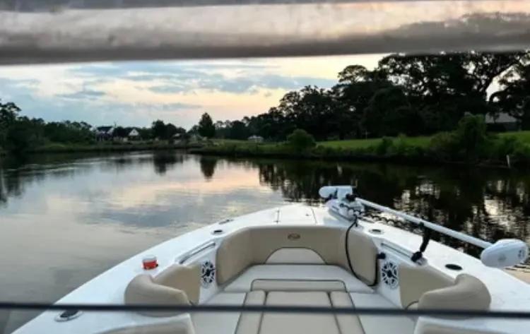 Slide: The Image of 2020 Key West 263 FS boat cruising on a serene river at sunset. - 12