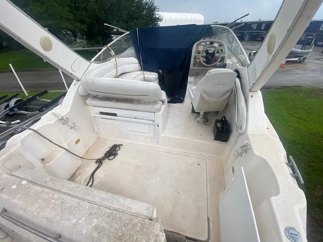Slide: The Image of 1998 Bayliner Ciara 2855 boat interior with white seating and steering area. - 8