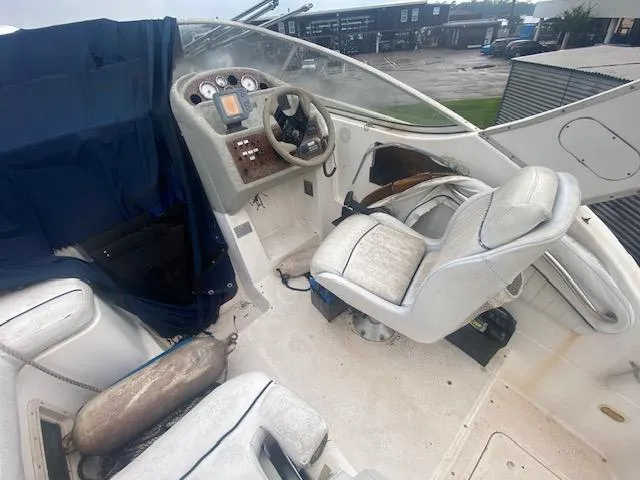 Slide: The Image of 1998 Bayliner Ciara 2855 boat cockpit with steering wheel and seating. - 9