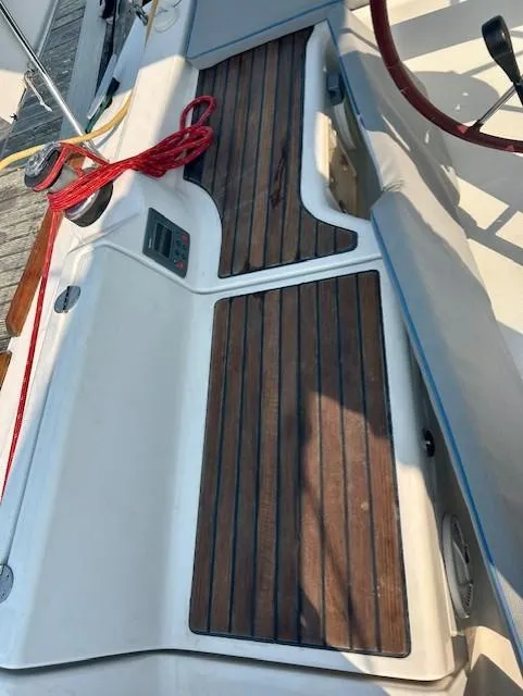 Slide: The Image of 2008 Beneteau Oceanis 31 sailboat deck with wood finish and red rope. - 17