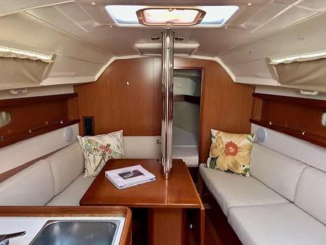 Slide: The Image of Interior of 2008 Beneteau Oceanis 31 sailboat with cozy seating and wooden finishes. - 20