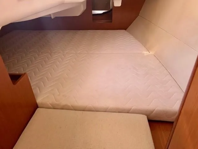 Slide: The Image of Interior cabin of 2008 Beneteau Oceanis 31 sailboat with cushioned sleeping area. - 23