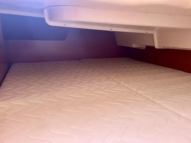 Slide: The Image of Cabin interior of 2008 Beneteau Oceanis 31 with a comfortable mattress. - 24