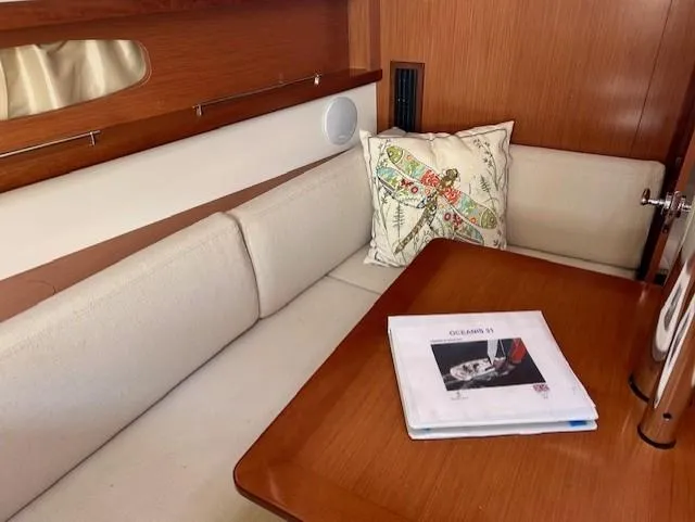 Slide: The Image of Cozy interior of 2008 Beneteau Oceanis 31 sailboat with seating and table. - 30