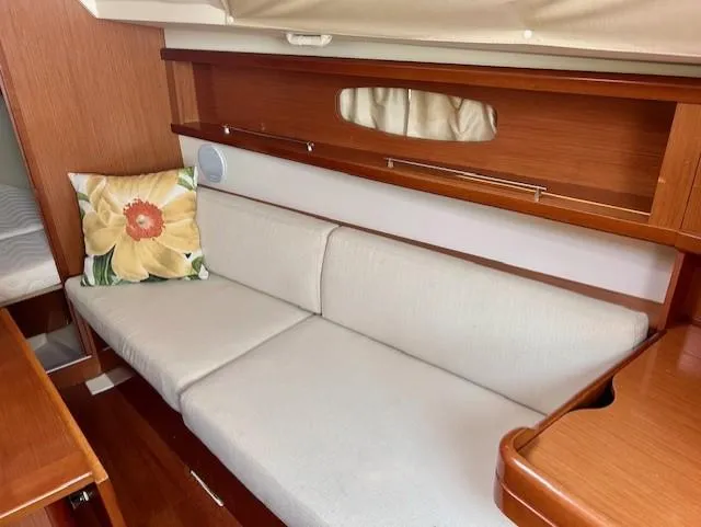Slide: The Image of Interior of 2008 Beneteau Oceanis 31, featuring a cozy sofa with floral cushion. - 31