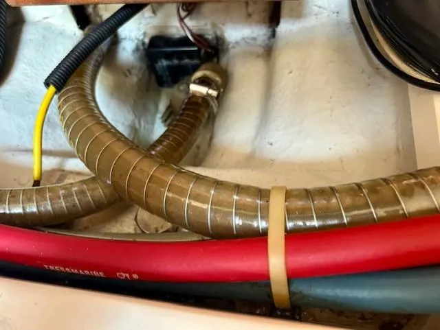 Slide: The Image of Engine compartment of 2008 Beneteau Oceanis 31 with hoses and wiring. - 34
