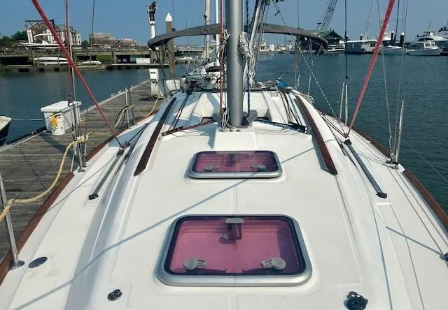 Slide: The Image of 2008 Beneteau Oceanis 31 sailboat docked at marina, showing deck and hatch details. - 4