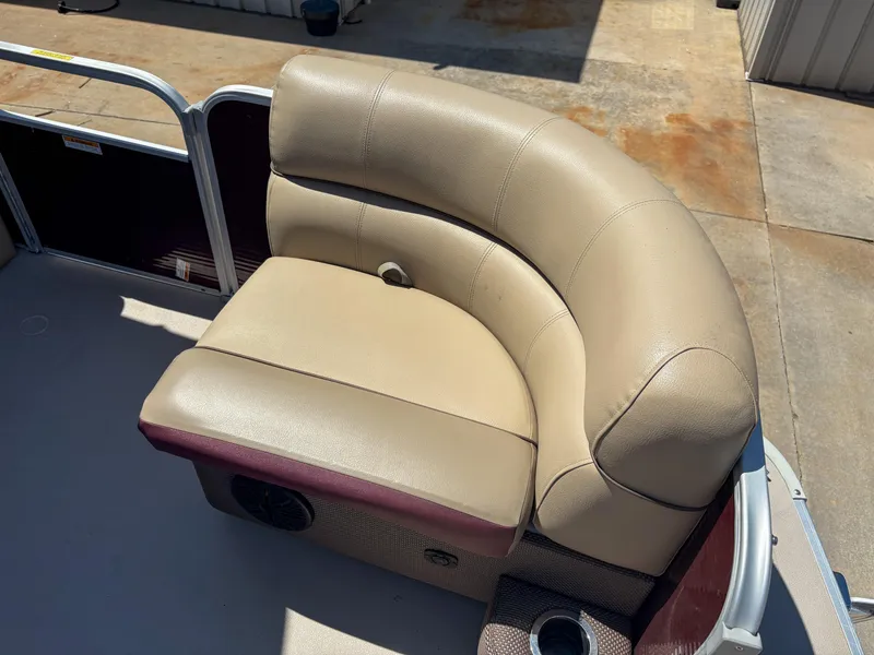 Slide: The Image of Beige leather seating on 2019 Sweetwater 2186 FS boat, featuring curved design and cup holder. - 4