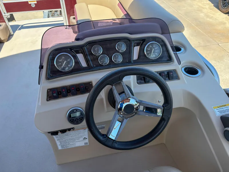 Slide: The Image of 2019 Sweetwater 2186 FS boat dashboard with steering wheel and instrument panel. - 8
