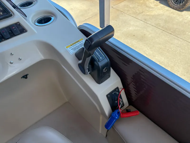 Slide: The Image of Control panel of a 2019 Sweetwater 2186 FS boat with throttle and safety lanyard. - 9