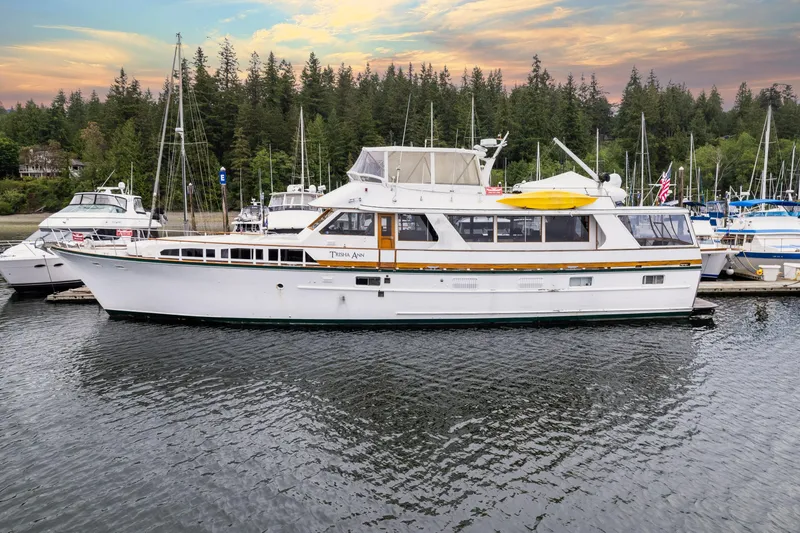 The Image of 1980 McQueen Motoryacht docked in a serene marina at sunset. - 0