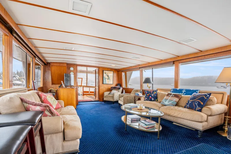 Slide: The Image of Luxurious 1980 McQueen Motoryacht interior with plush seating, elegant decor, and panoramic windows. - 19
