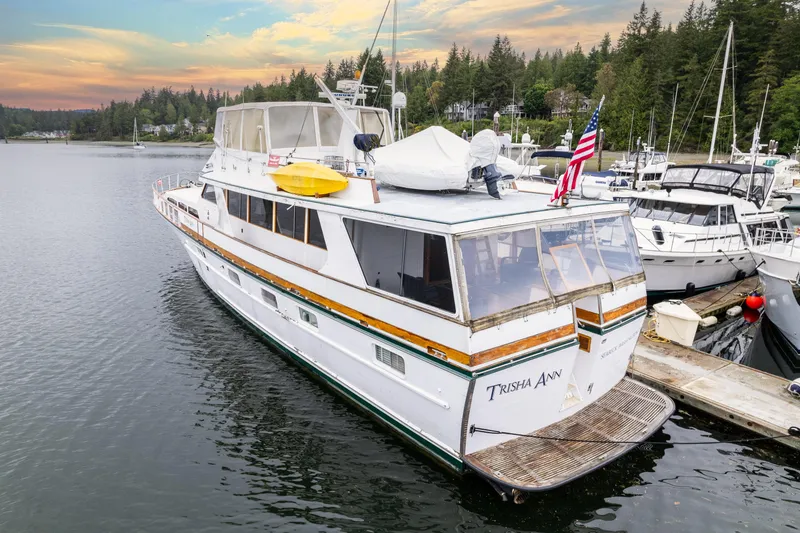 Slide: The Image of 1980 McQueen Motoryacht docked in serene marina at sunset. - 2