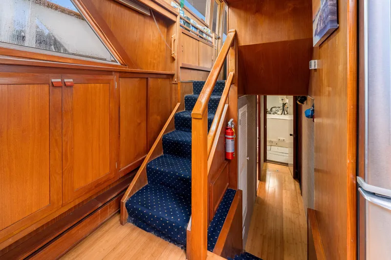 Slide: The Image of Interior of 1980 McQueen Motoryacht with wooden stairs and blue carpet. - 37