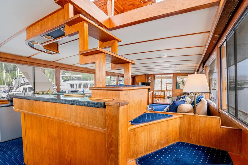 Slide: The Image of Luxurious 1980 McQueen Motoryacht interior with wooden finishes and blue accents. - 38