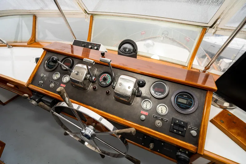 Slide: The Image of 1980 McQueen Motoryacht helm with vintage controls and gauges. - 44