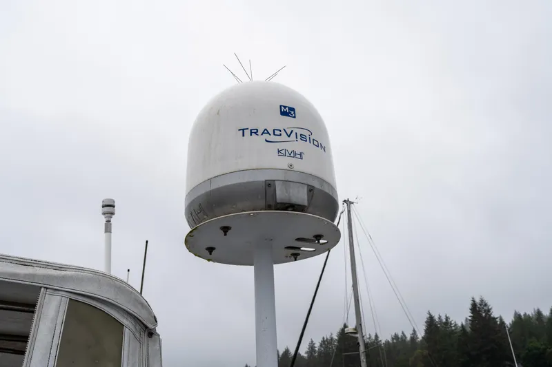 Slide: The Image of Satellite dome on 1980 McQueen Motoryacht against cloudy sky and forest background. - 48